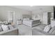 Bright main bedroom featuring a soothing color palette, large bed and walk-in shower at 889 Terrapin Dr, Debary, FL 32713