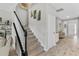 Carpeted stairs leading to second story with half wall and living room views at 889 Terrapin Dr, Debary, FL 32713