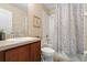 Compact bathroom showcases a vanity, toilet, shower with curtain, and neutral color scheme at 901 Dorset Pl, Davenport, FL 33896