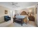 Spacious bedroom with an elegant wooden bed frame, bench and natural light creates a welcoming atmosphere at 901 Dorset Pl, Davenport, FL 33896