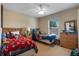 Cozy bedroom with twin beds, plush toys, and natural light streaming through the window, perfect for  at 901 Dorset Pl, Davenport, FL 33896