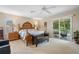 Spacious main bedroom with elegant wooden bed frame, a leather bench and access to screened outdoor patio at 901 Dorset Pl, Davenport, FL 33896