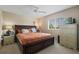 Comfortable bedroom featuring a large bed with storage drawers and window letting in plenty of natural light at 901 Dorset Pl, Davenport, FL 33896