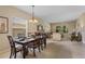 Elegant dining area flows seamlessly into a comfortable living space, perfect for gatherings and everyday living at 901 Dorset Pl, Davenport, FL 33896