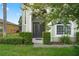 Charming front entrance framed by manicured hedges and lush lawn, creating a welcoming first impression at 901 Dorset Pl, Davenport, FL 33896