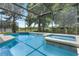 Inviting screened-in pool with an attached spa, creating a private oasis for relaxation and recreation at 901 Dorset Pl, Davenport, FL 33896