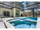 A screened-in pool with an attached spa is perfect for relaxation and entertainment at 901 Dorset Pl, Davenport, FL 33896