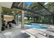 A screened-in in-ground pool and covered patio is the perfect setting for relaxation and entertaining at 901 Dorset Pl, Davenport, FL 33896