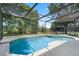An in-ground screened-in pool and patio furniture offer the perfect spot for recreation and relaxation at 901 Dorset Pl, Davenport, FL 33896