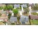 Overhead view of neighborhood with house featuring a screened pool and well-maintained yard at 924 Mill Road Ln, Port Orange, FL 32127