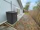 Backyard of the property showing AC Unit, french doors, and side-yard fencing at 924 Mill Road Ln, Port Orange, FL 32127