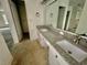 Bathroom with double granite vanity, cabinets, and a view to closet at 924 Mill Road Ln, Port Orange, FL 32127
