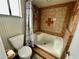 Bathroom with tile walls, toilet, shower, and small window at 924 Mill Road Ln, Port Orange, FL 32127