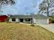 Charming single-story home featuring a well-maintained yard and a two-car garage at 924 Mill Road Ln, Port Orange, FL 32127