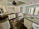 Bright kitchen featuring stainless steel appliances, white cabinets, and granite countertops during renovation at 924 Mill Road Ln, Port Orange, FL 32127