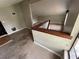 Upstairs landing featuring view of the carpeted upper level and access to other rooms at 924 Mill Road Ln, Port Orange, FL 32127