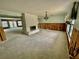 A living room with a stone fireplace, chandelier, and views of the backyard through sliding glass doors at 924 Mill Road Ln, Port Orange, FL 32127