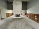A large, open living room with a stone fireplace in the center of the room at 924 Mill Road Ln, Port Orange, FL 32127
