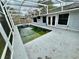 A screened in pool with a hot tub situated beside a light blue house at 924 Mill Road Ln, Port Orange, FL 32127