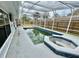 A screened pool and spa featuring an outdoor kitchen and a fenced in yard at 924 Mill Road Ln, Port Orange, FL 32127