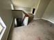 Upstairs landing featuring a staircase to the lower level and view of the carpeted upper level at 924 Mill Road Ln, Port Orange, FL 32127
