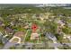 Drone view highlighting this residential home's location in a neighborhood surrounded by lush trees at 109 Sweetwater Oaks Ln, Daytona Beach, FL 32114