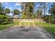 Open backyard with a stone tiled patio set and a well maintained lawn. A wood fence defines the perimeter at 109 Sweetwater Oaks Ln, Daytona Beach, FL 32114