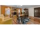 The dining room has an elegant stone fireplace, a wooden table set on a patterned rug, and warm lighting at 109 Sweetwater Oaks Ln, Daytona Beach, FL 32114