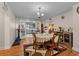 Elegant dining room with wood floors, a round table, and access to the kitchen at 109 Sweetwater Oaks Ln, Daytona Beach, FL 32114