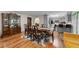 Dining room with an antique china cabinet, modern rug, and access to the kitchen and a bar seating area at 109 Sweetwater Oaks Ln, Daytona Beach, FL 32114