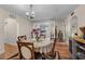 Dining room with a round table and chairs, view of the kitchen through glass doors at 109 Sweetwater Oaks Ln, Daytona Beach, FL 32114