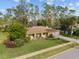 Landscaped front yard with mature trees framing this well-kept single-Gathering home at 109 Sweetwater Oaks Ln, Daytona Beach, FL 32114