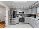 Well-equipped kitchen featuring stainless steel appliances and gray cabinets at 109 Sweetwater Oaks Ln, Daytona Beach, FL 32114