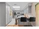 Modern kitchen with gray cabinets, stainless steel appliances, and a breakfast bar with stools at 109 Sweetwater Oaks Ln, Daytona Beach, FL 32114