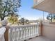 Balcony view showcasing the balustrade, nearby trees, and body of water in the distance at 1110 W Ivanhoe Blvd # 6, Orlando, FL 32804