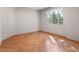 Bright bedroom with a large window, hardwood floors, and neutral paint at 1110 W Ivanhoe Blvd # 6, Orlando, FL 32804