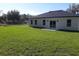 Beautiful shot of the rear of the house and large yard with verdant grass, perfect for outdoor enjoyment at 13215 Sw 41St Ct, Ocala, FL 34473