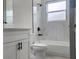 Elegant bathroom with marble-look tile, white cabinets, modern fixtures, and lots of natural light at 13215 Sw 41St Ct, Ocala, FL 34473