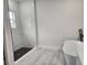 Modern bathroom featuring a glass-enclosed shower, modern tub, and stylish black hardware at 13215 Sw 41St Ct, Ocala, FL 34473