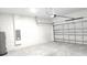 Spacious two car garage with cinder block walls and a metal door at 13215 Sw 41St Ct, Ocala, FL 34473