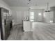 Bright, open kitchen featuring an island, stainless steel appliances, and modern light fixtures at 13215 Sw 41St Ct, Ocala, FL 34473