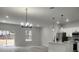 Bright living room and kitchen area with wood-look floors, recessed lighting, and stainless steel appliances at 13215 Sw 41St Ct, Ocala, FL 34473