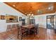 Spacious dining room with wood-paneled ceiling, tile flooring, and adjacent kitchen at 133 Heron Bay Cir, Lake Mary, FL 32746