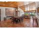 Open concept dining area with wood-paneled ceiling, tile floors, and view to the living room at 133 Heron Bay Cir, Lake Mary, FL 32746