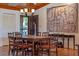 Charming dining room featuring hardwood table, decorative chandelier and terra cotta tile floors at 133 Heron Bay Cir, Lake Mary, FL 32746