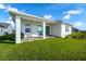 Green backyard with a covered porch and a grill at 13589 Mcmillan Dr, Orlando, FL 32827