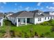 Beautiful backyard featuring a covered patio, manicured lawn, and serene waterfront views, perfect for outdoor relaxation at 13589 Mcmillan Dr, Orlando, FL 32827