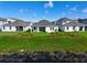 Backyard view from the pond, highlighting the lush landscaping, modern patio, and serene outdoor living space at 13589 Mcmillan Dr, Orlando, FL 32827