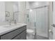 Modern bathroom with glass-enclosed shower, gray vanity with quartz countertop, and contemporary fixtures at 13589 Mcmillan Dr, Orlando, FL 32827