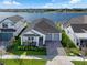 Beautiful single-Gathering home with a two-car garage, a well-manicured lawn, and stunning lake views at 13589 Mcmillan Dr, Orlando, FL 32827